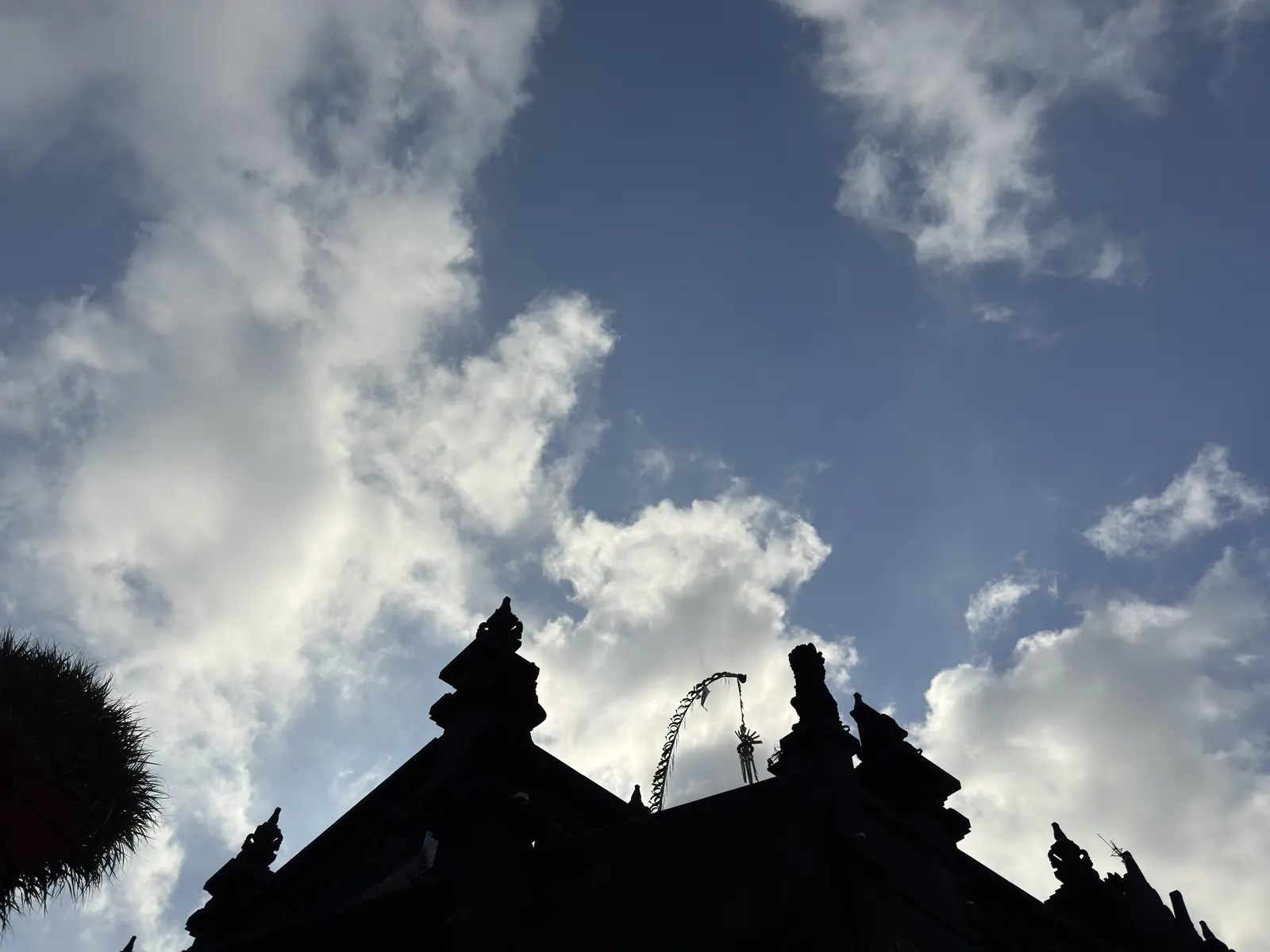 Carved temple roof against the sky at Batu Bolong