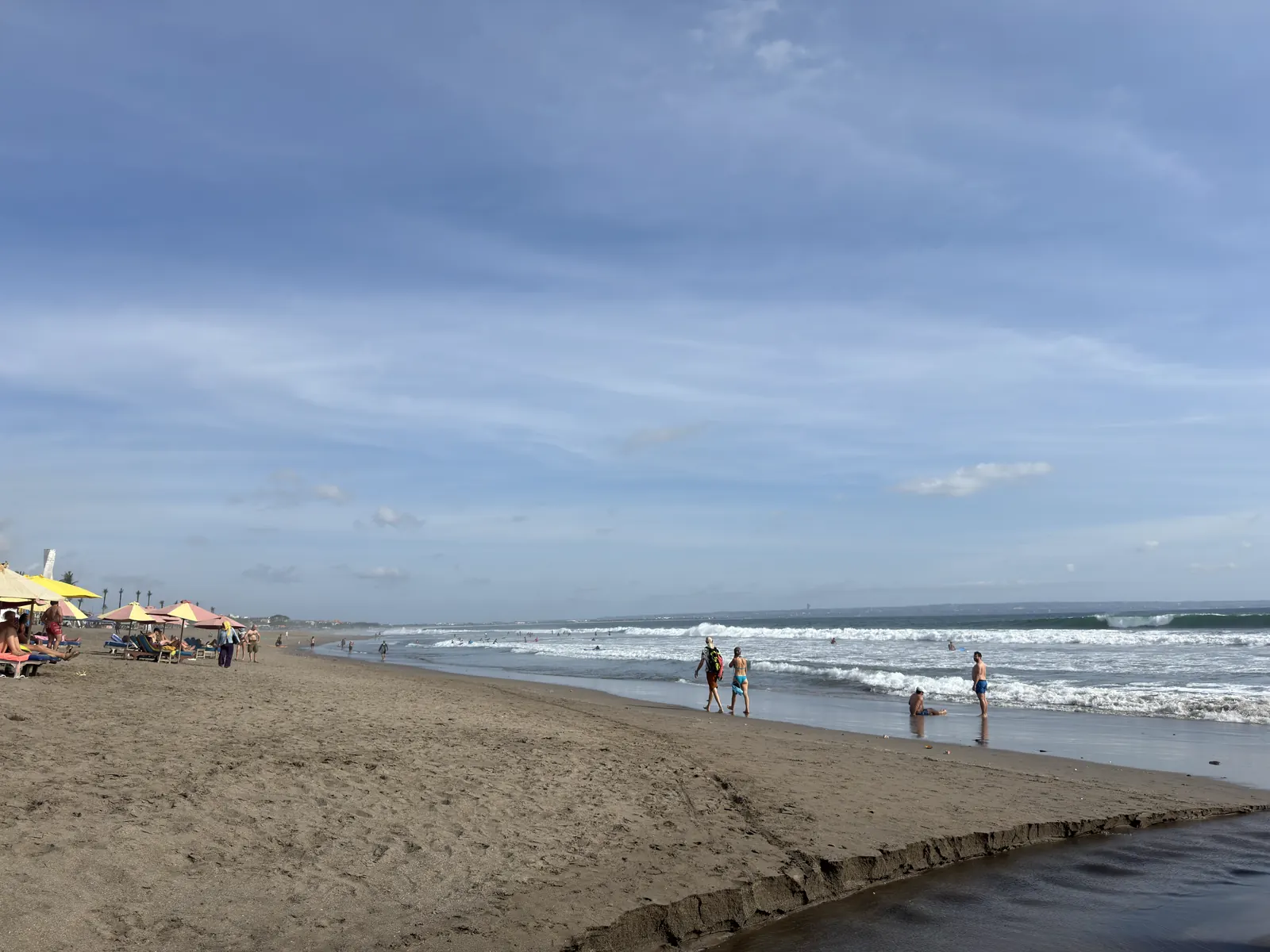 People walking on the sand at Berawa beach