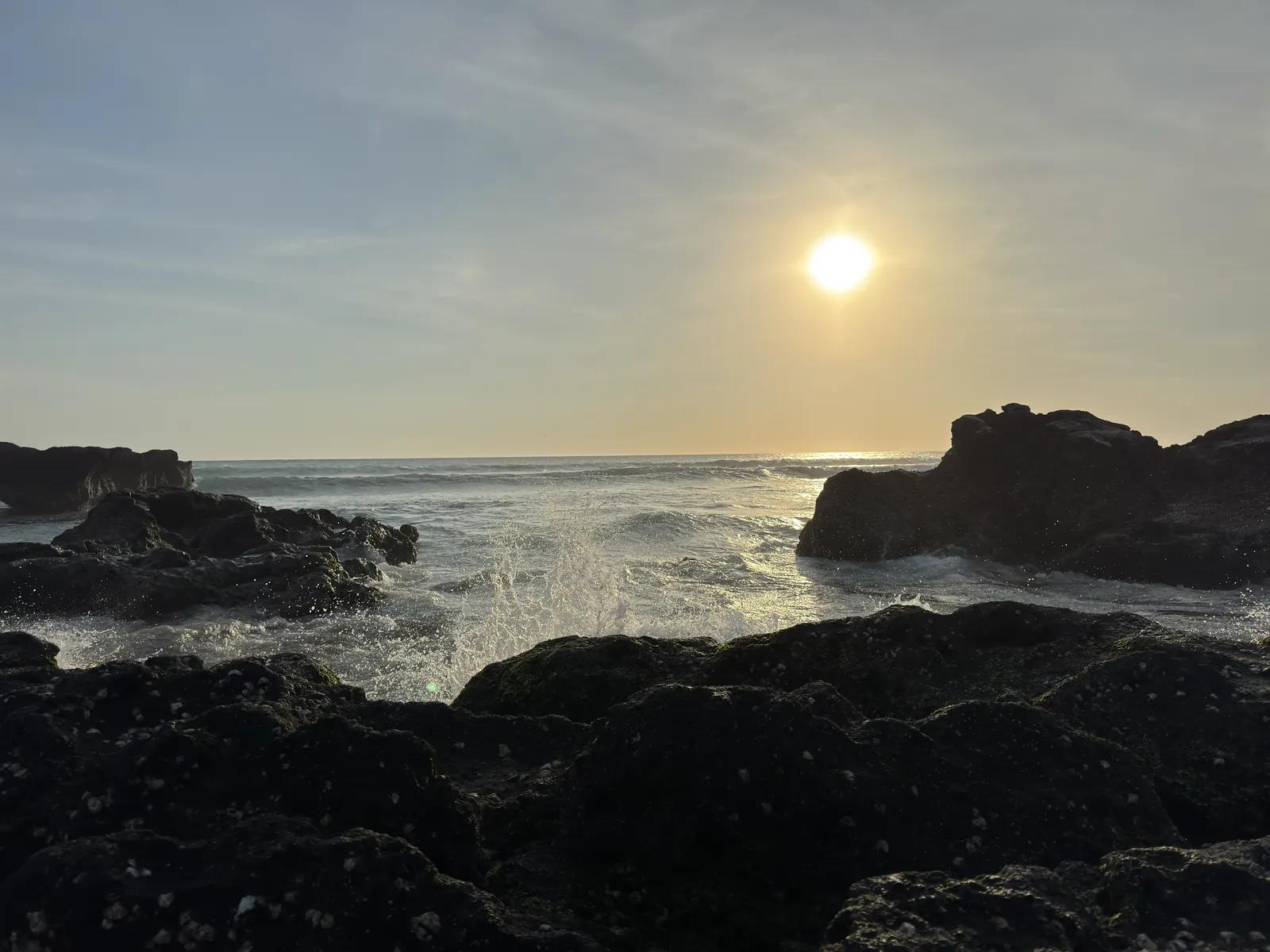 Late sun over the rocks and surf at Echo Beach