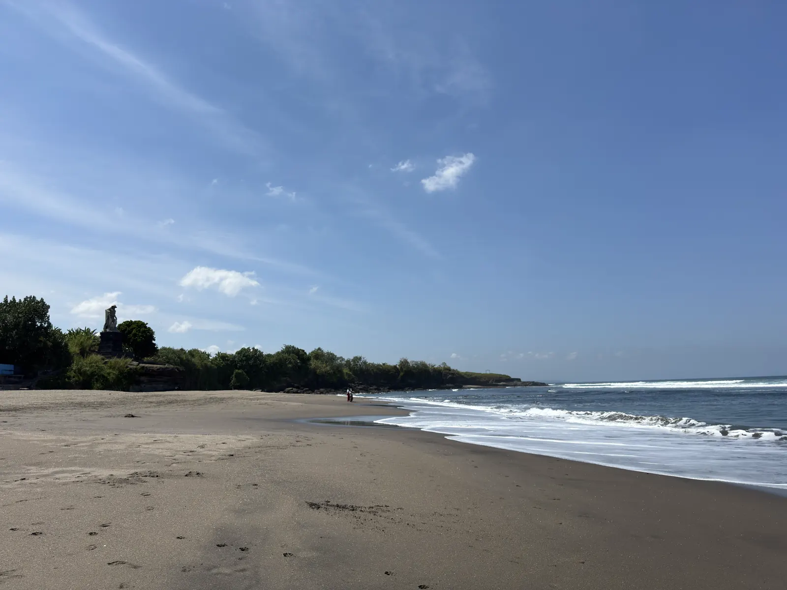 A quiet stretch of dark sand at Kedungu beach