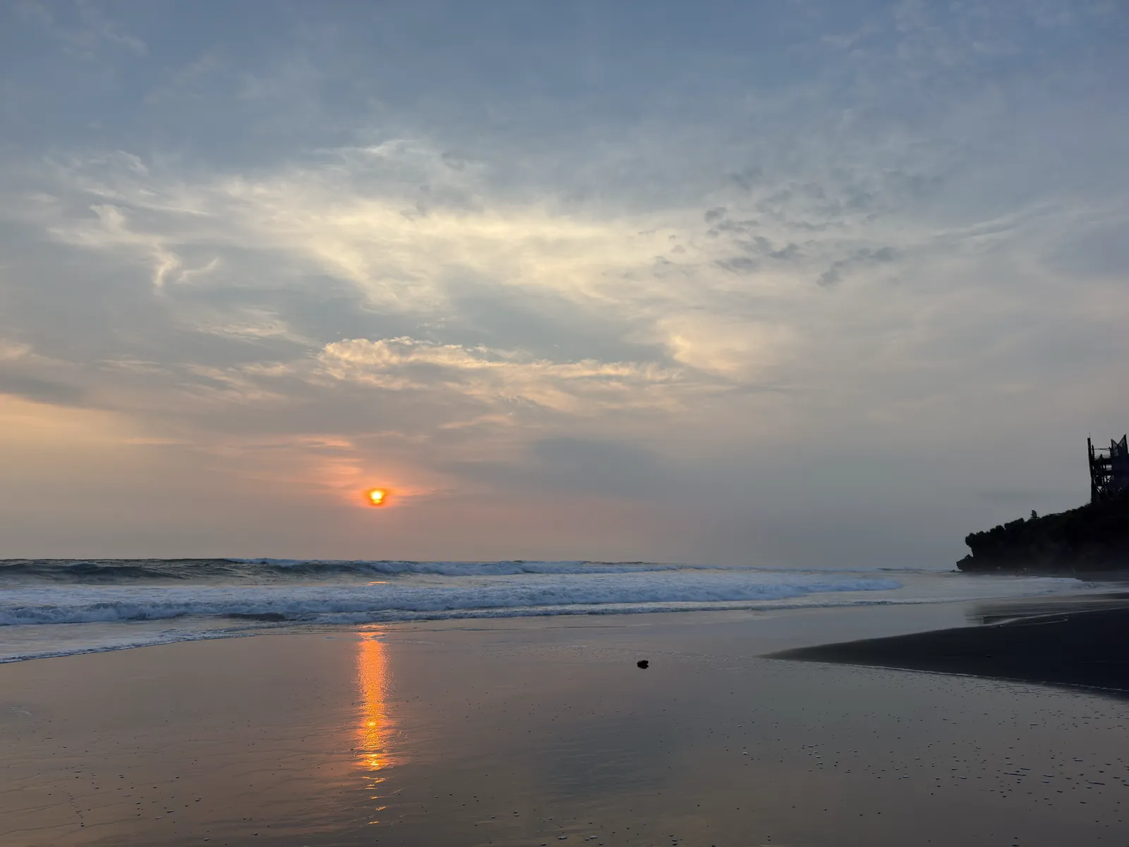 Sunset over the black sand beach at Nyanyi