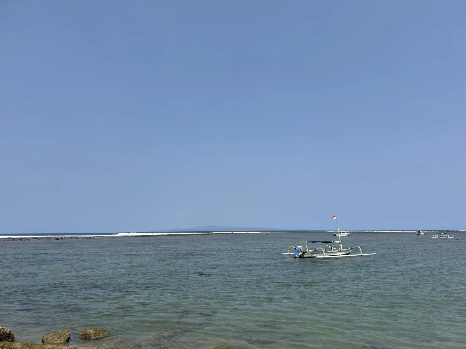 A fishing boat on calm water off Sanur